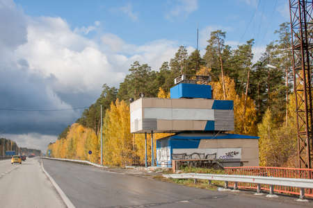 Yekaterinburg, Russia - October 02.2016: Autumn landscape with a small building near the road and the beautiful blue skyのeditorial素材