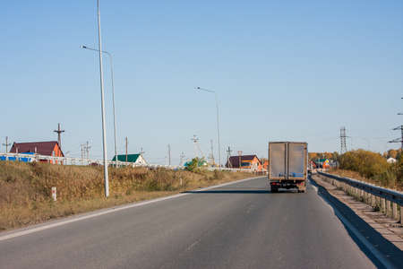 Tyumen, Russia - October 01.2016: Rural landscape and truck driving on roadのeditorial素材