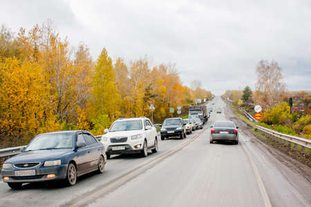Yekaterinburg, Russia - October 02.2016: Car traffic on the highway, autumn landscapeのeditorial素材