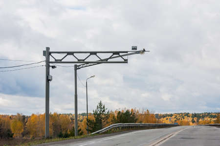 Revda, Russia -  Road and videocameras of tracking, an autumn landscape