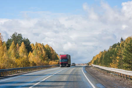 Revda, Russia - October 02.2016: Autumn landscape with road, cars and beautiful blue skyのeditorial素材