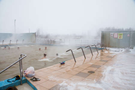 Tyumen, Russia - November 05.2016: People in pool with hot mineral water in winter, a thermal source ' Soviet 'のeditorial素材