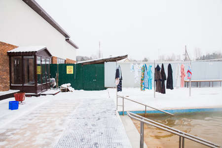 Dressing gownes and towels hang on a hanger in the street in winterの写真素材