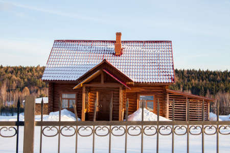 Wooden modern house behind a fence, Sverdlovsk Region, Russia