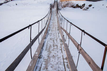 Suspended pedestrian bridge in the village of Sloboda, Sverdlovsk region, Russiaの写真素材