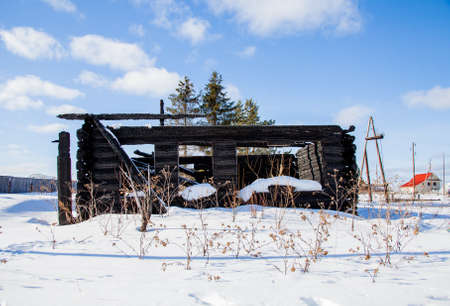 Wooden house after a fire in the village, Sverdlovsk region, Russiaの写真素材