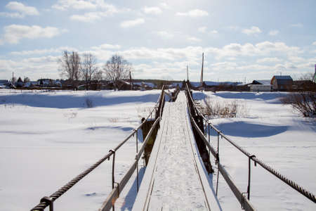 Suspension bridge across the river Chusovaya in the village of Sloboda, Sverdlovsk region, Russiaの写真素材