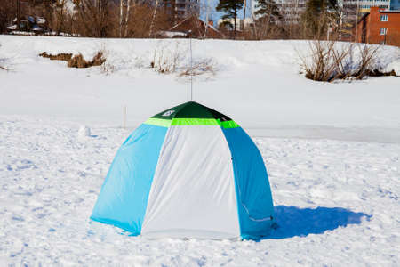 Tent of the fisherman in the winter afternoon on the frozen riverの写真素材