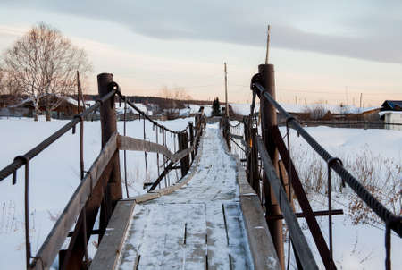 Suspended pedestrian bridge in the village of Sloboda, Sverdlovsk region, Russiaの写真素材