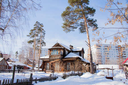 Winter landscape with the wooden house a sunny dayの写真素材