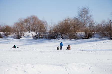 Perm, Russia - March 11.2017: Fishermen catch fish in the winter in the backwater of the frozen Kama riverのeditorial素材