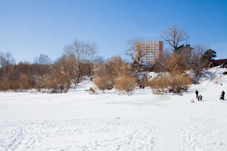 Perm, Russia - March 11.2017: Children ride a slide in the winter in the backwaters of the Kama riverのeditorial素材