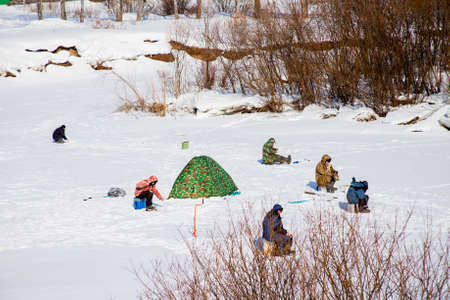 Russia, Sverdlovsk region, the village of Sloboda - March 01.2017: Fishermen in the winter on the river Chusovayaのeditorial素材