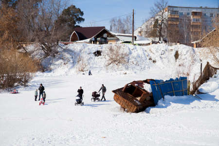 Perm, Russia - March 11.2017: Children ride a slide in the winter in the backwaters of the Kama riverのeditorial素材