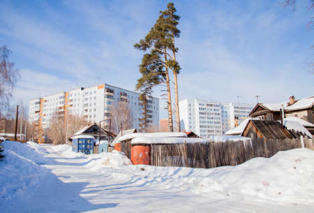 Perm, Russia - March 11.2017: Winter landscape with old and new houses on a sunny afternoonのeditorial素材