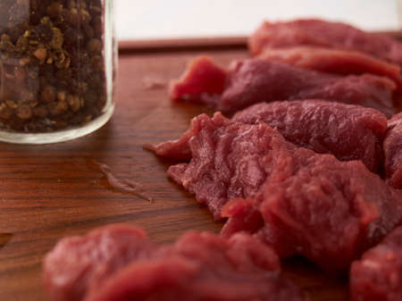 cooking a meat dish. Meat and a meat cleaver on a chopping board
