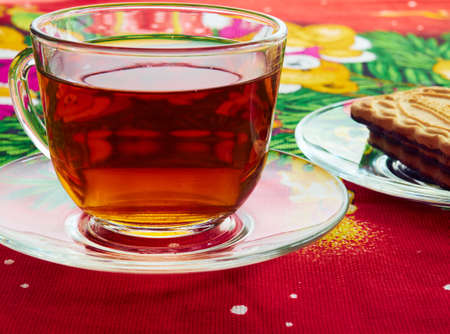 poured into a Cup of hot tea and biscuits on the saucerの写真素材