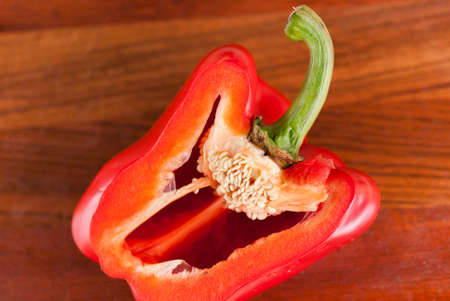 lying cut on a chopping Board red pepper. Visible grains of pepperの写真素材