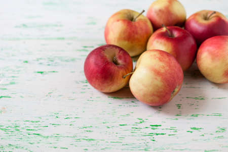 some apples lie on a wooden background