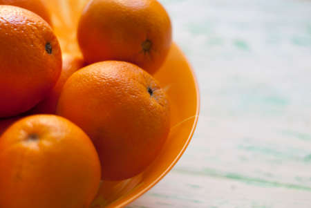 Dish with oranges stands on the old boardの写真素材