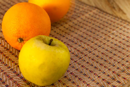 Apple and oranges are on the tableの写真素材