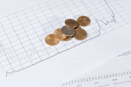 Stacks of coins on financial charts. Concept business investment planの写真素材
