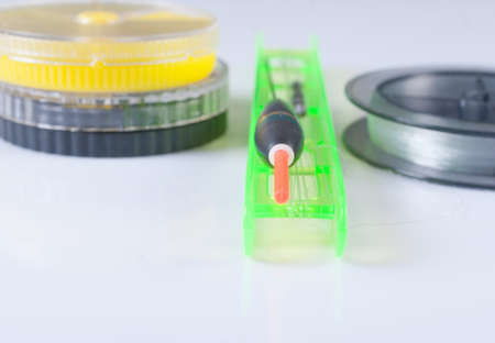 Accessories for fishing. Float, fishing line and a box. Focus on the floatの写真素材