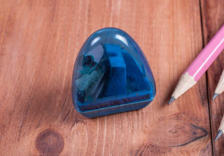 sharpener and pencils on the wooden backgroundの写真素材
