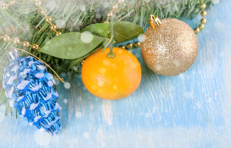Christmas balls, yellow mandarin with the bokeh and blurred falling snowの写真素材