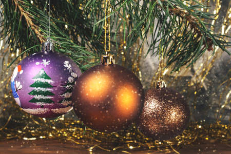 Christmas balls on the branches with falling snowflakesの写真素材