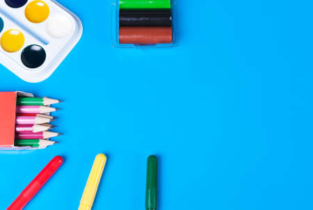 Watercolours, plasticine and felt-tip pens on a blue backgroundの写真素材