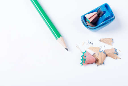 The open blue pencil sharpener and pencils lying on a white background not isolatedの写真素材