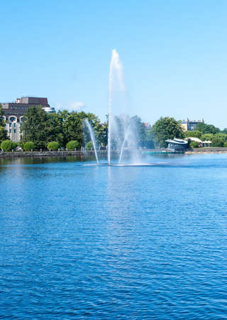 Fountain in the middle of the river in a summer sunny dayの写真素材