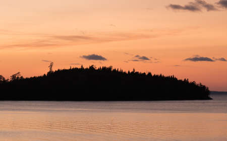 Sunset on the Ladoga lake. Silhouettes of islands on the horizonの写真素材