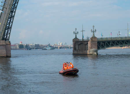 SAINT-PETERSBURG, RUSSIA - JULY 20, 2017: Boat of Rescue Service on the background of a divorced bridge in St. Petersburg, Russiaのeditorial素材