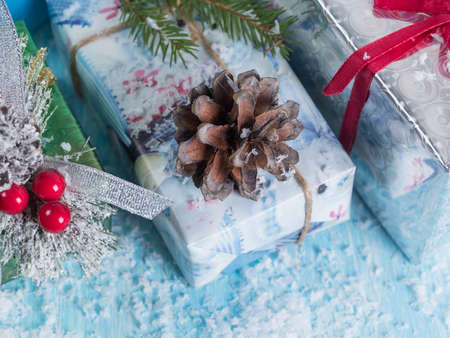 Multicolored boxes with gifts on a snow-covered background. Top view.