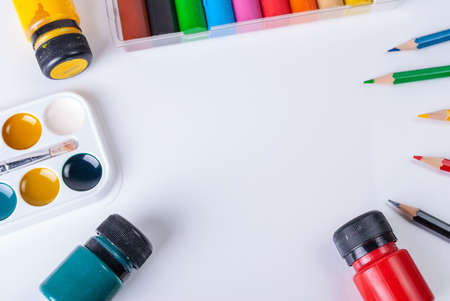 Paint, colored pencils, plasticine on a white background with copy space