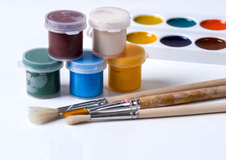 Gouache in jars, brushes and watercolors on a white backgroundの写真素材