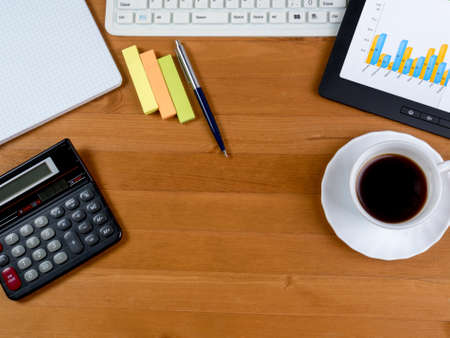 Top view of the working space of the table with office supplies, white keyboard and tabletのeditorial素材