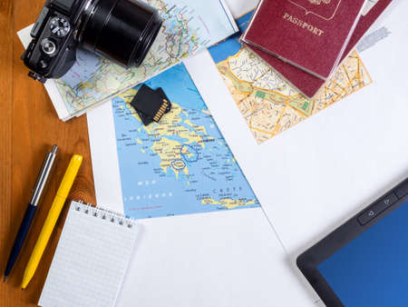 Travel maps, passports, camera, pens and notepad and tablet