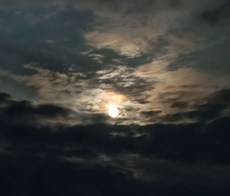 Bright moon in the clouds in the night sky