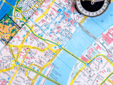 Planning a trip around the city. Compass on a map with a transport schemeの写真素材