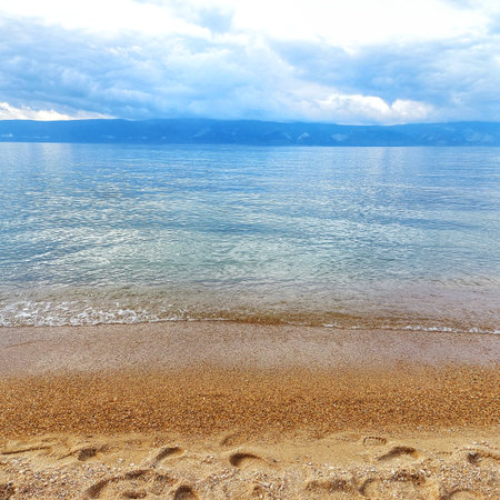 beautiful sandy beach on the shore of lake.の写真素材