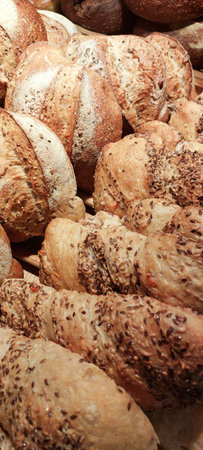 Different types of bread on a market stall, close-up.