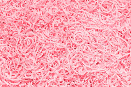 Tinted textured background from the scattered macaroni, pinkの写真素材