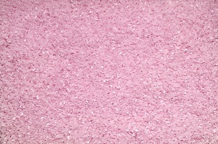 Textured background of rice grains scattered on the surfaceの写真素材