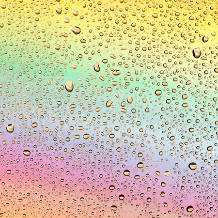 Water drops on a background of iridescent glass.の写真素材