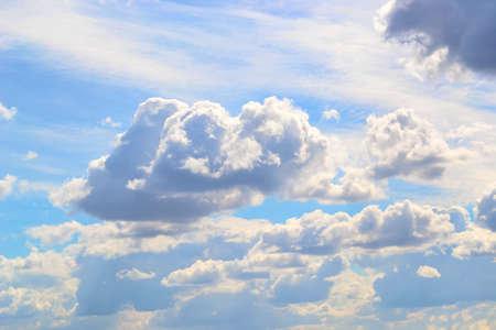 Natural background and a blue summer sky with sun-lit clouds