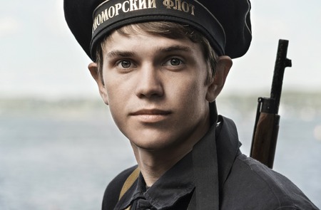 Historical festival of the Second World war in Samara to celebrate the Day of the Navy, July 26, 2015. Portrait of a cabin boy on the background of the Volga river.のeditorial素材