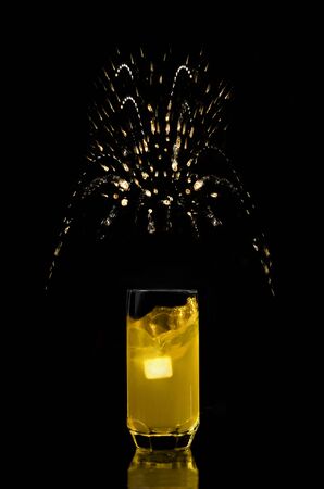 Lemonade in a glass, ice and and splashes, on a black backgroundの写真素材